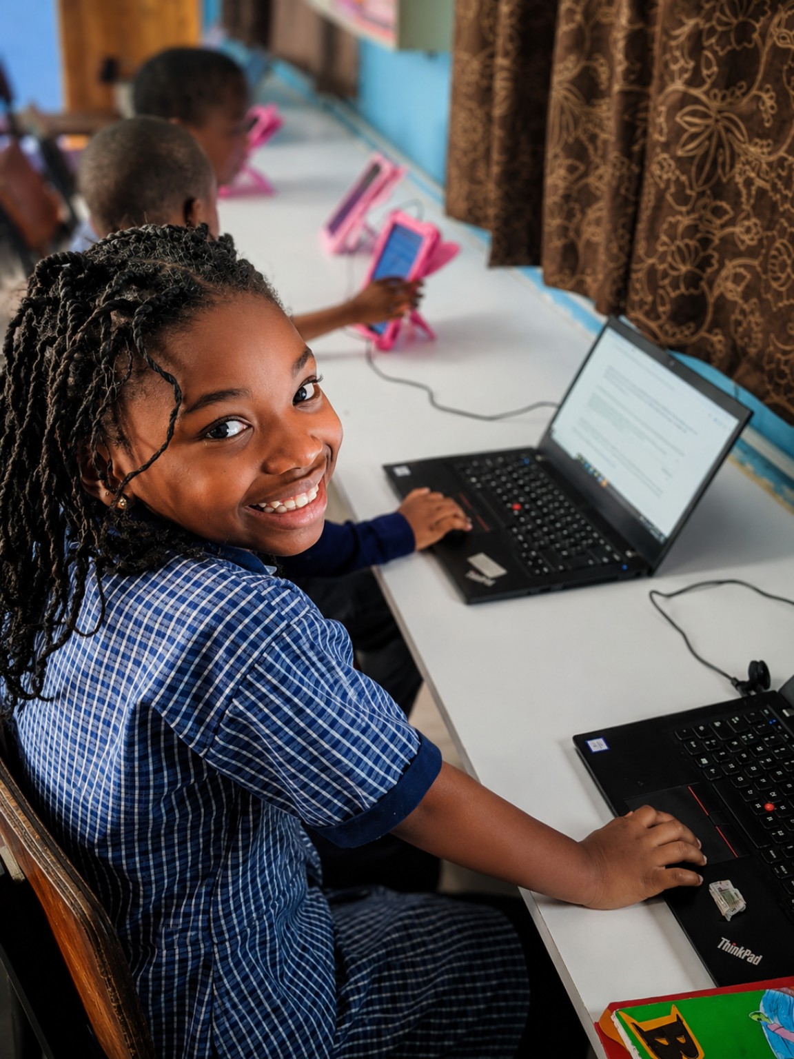 A learner using a laptop during a Technology Assisted Learning guided tuition session in Kalulushi